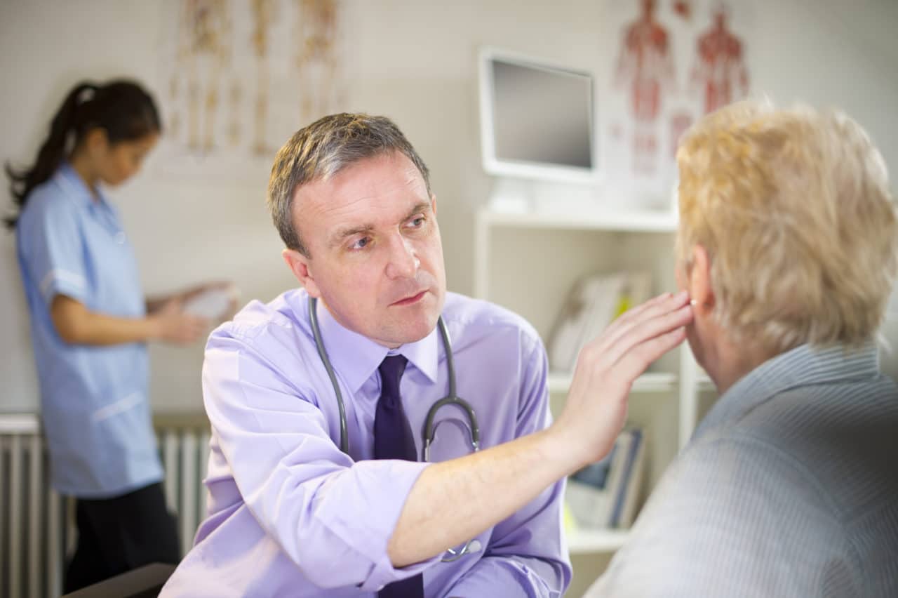 doctor looking into patients ear