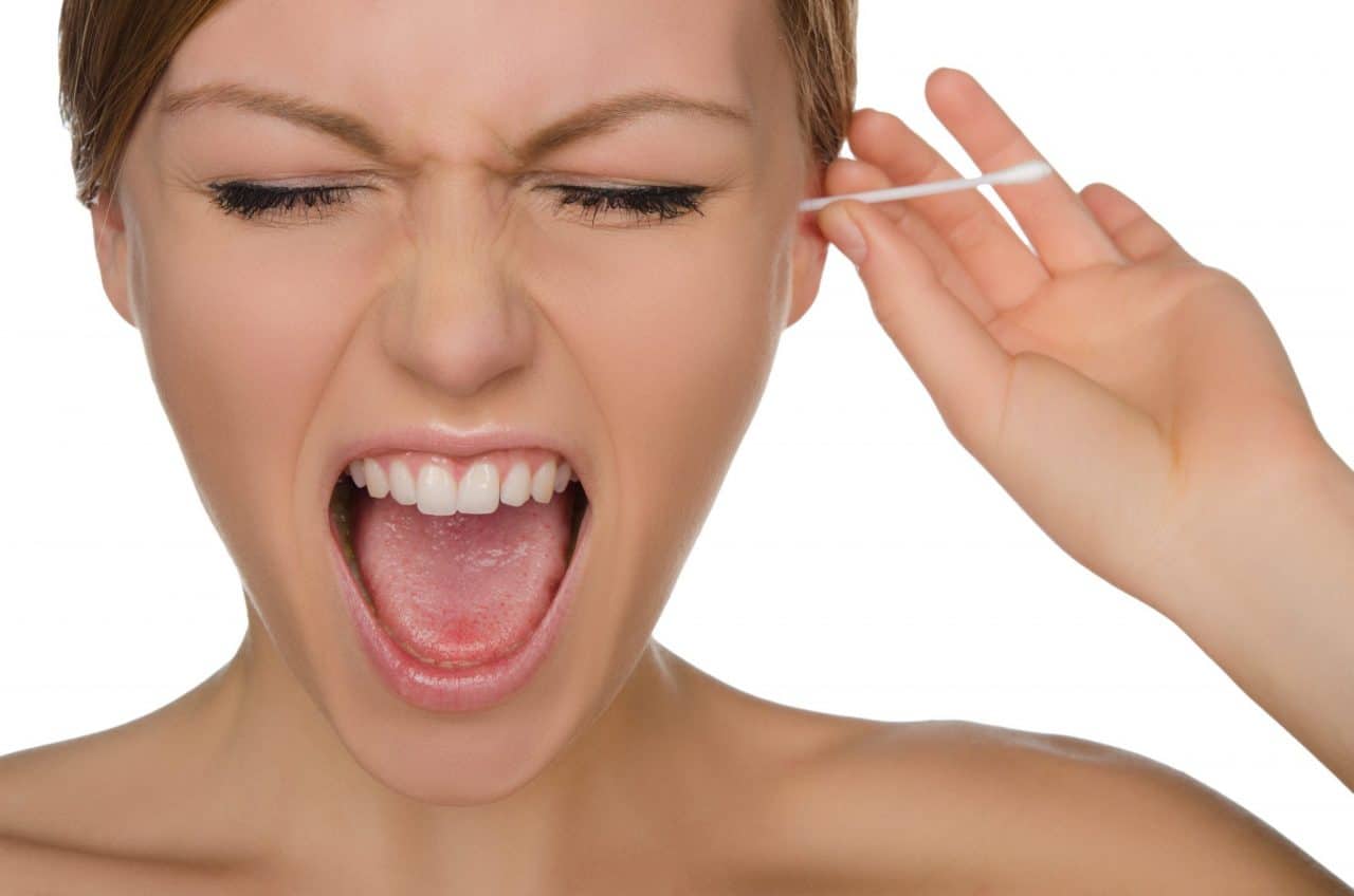 Woman screams while putting an ear swab in her ear