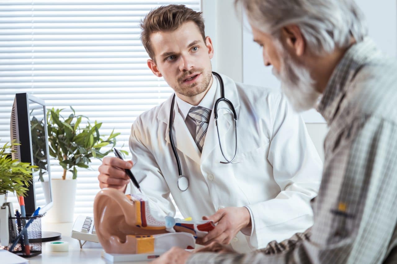 Audiologist explaining hidden hearing loss to patient.