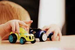 Children playing with toy cars.