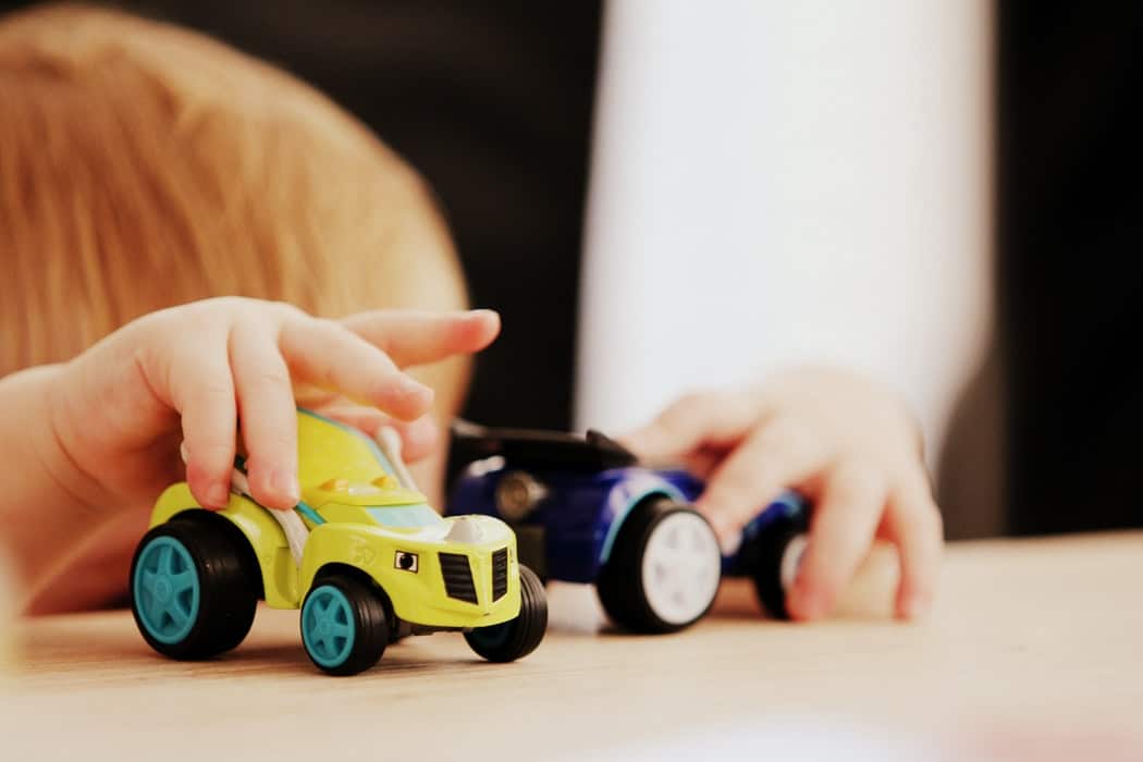 Children playing with toy cars.