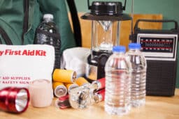 Emergency preparedness natural disaster supplies. Water, flashlight, lantern, batteries.