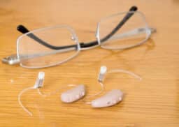 Close-up of hearing aids and glasses