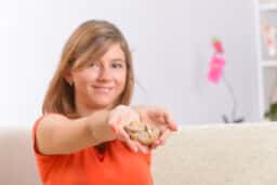 Young woman holding her new hearing aids