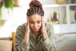 Anxious woman holding her temples