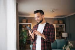 An adult man is using his smartphone