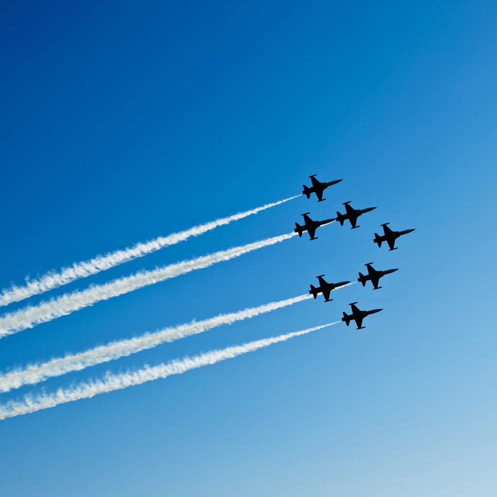 Fighter planes in airshow on blue sky