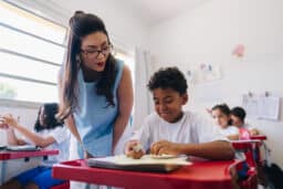 Teacher reviewing her students work