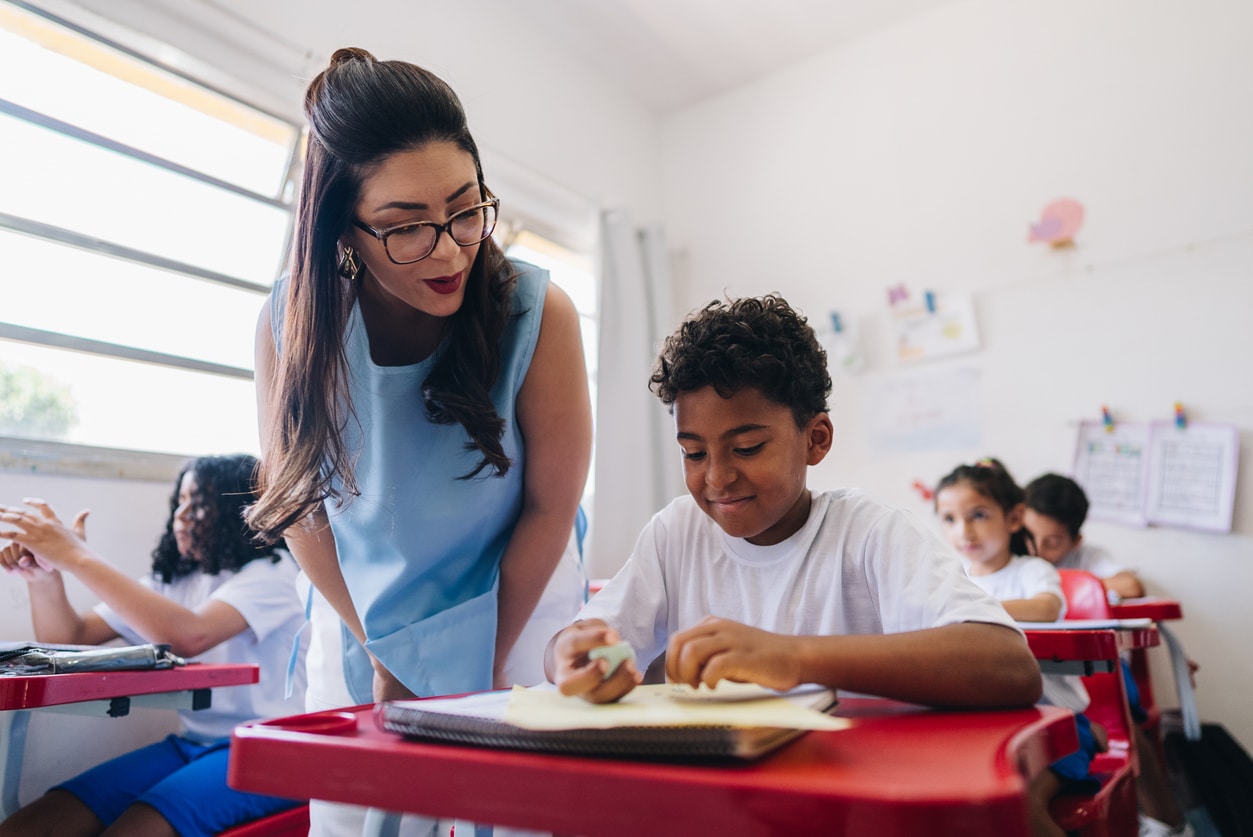 Teacher reviewing her students work