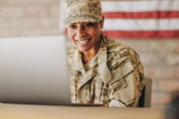 Smiling US Soldier using a computer